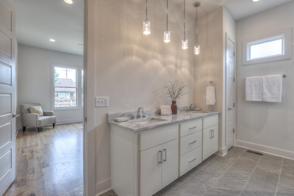 Mid-sized transitional 3/4 bathroom in Nashville with flat-panel cabinets, white cabinets, an alcove shower, white tile, subway tile, white walls, porcelain floors, an undermount sink and quartzite benchtops.