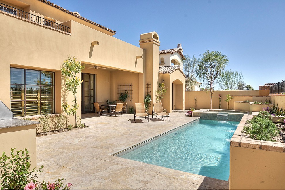 Inspiration for a mid-sized mediterranean backyard rectangular pool remodel in Phoenix