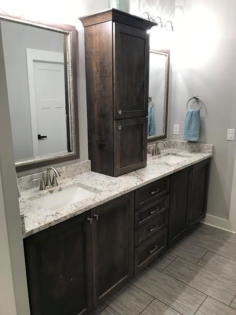 Photo of a master bathroom in Indianapolis with shaker cabinets, dark wood cabinets, an undermount sink and granite benchtops.