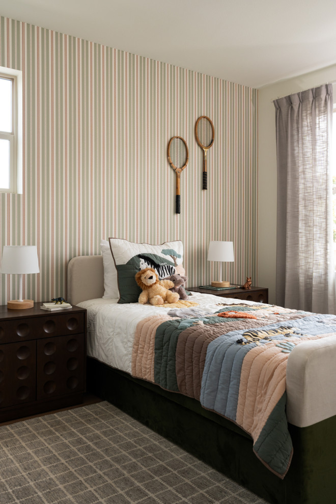 Bedroom tuscan boy medium tone wood floor, brown floor and wallpaper kids' bedroom photo in Los Angeles with multicolored walls