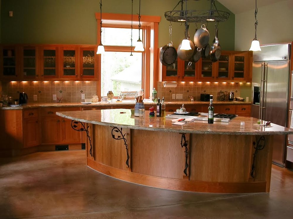 Mid-sized transitional l-shaped concrete floor eat-in kitchen photo in Seattle with a drop-in sink, shaker cabinets, medium tone wood cabinets, granite countertops, gray backsplash, ceramic backsplash, stainless steel appliances and an island