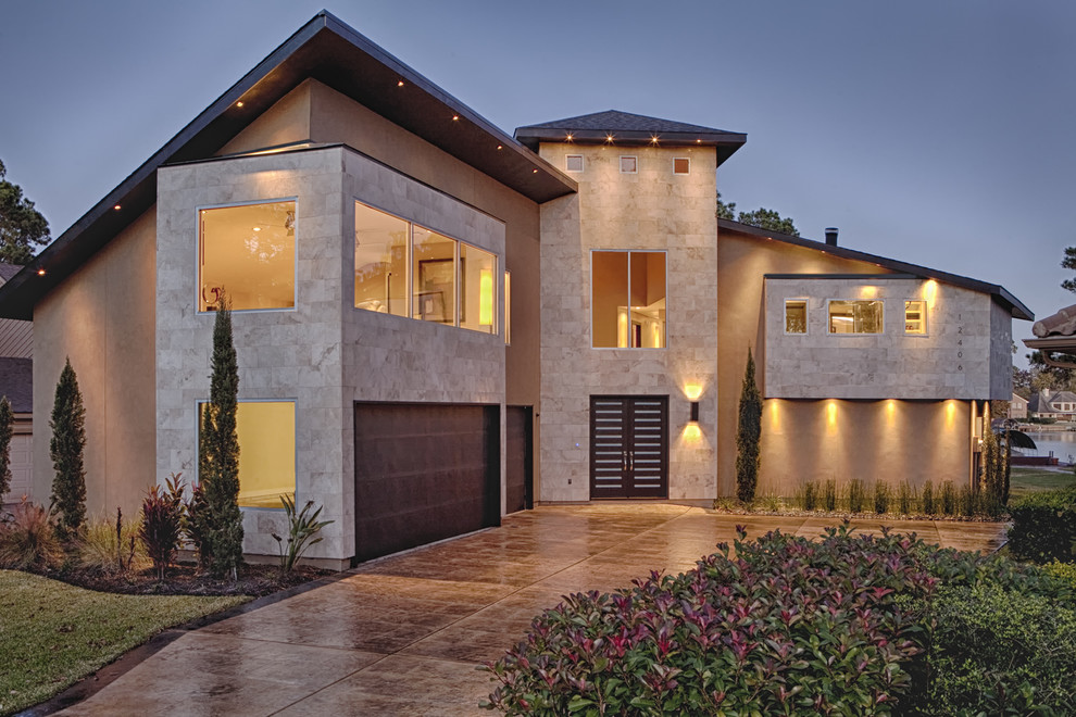 Mid-sized contemporary three-storey beige exterior in Houston with stone veneer and a hip roof.