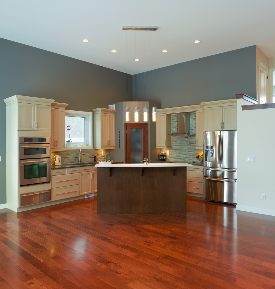 Inspiration for a large medium tone wood floor eat-in kitchen remodel in Minneapolis with an undermount sink, white cabinets, multicolored backsplash, stainless steel appliances and an island