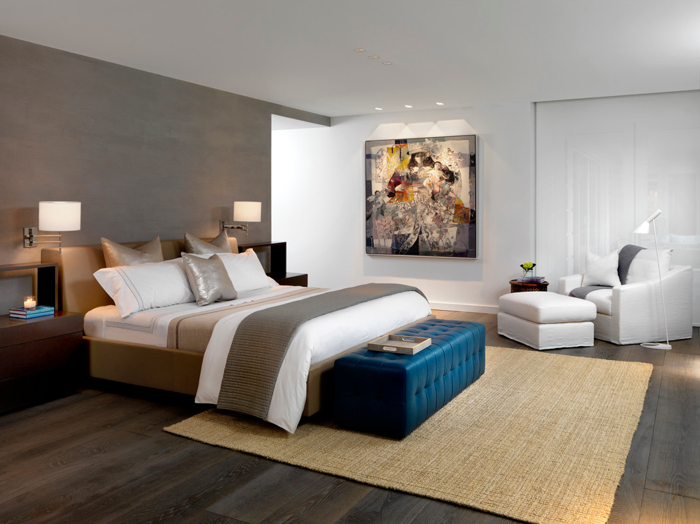 This is an example of a contemporary bedroom in Miami with white walls and dark hardwood floors.