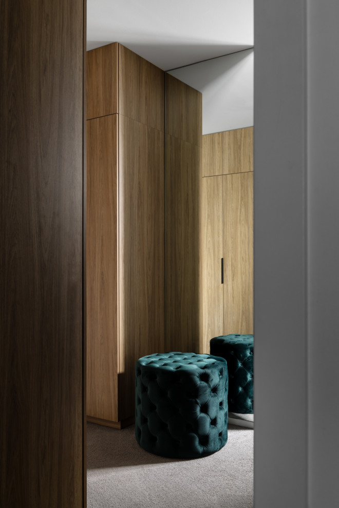 Medium sized contemporary gender neutral built-in wardrobe in Melbourne with carpet.