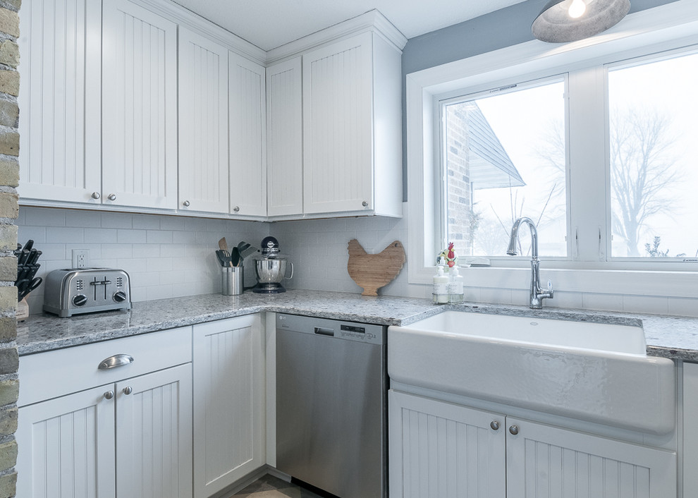 Small country u-shaped kitchen pantry in Minneapolis with a farmhouse sink, beaded inset cabinets, white cabinets, granite benchtops, white splashback, ceramic splashback, stainless steel appliances, no island and linoleum floors.