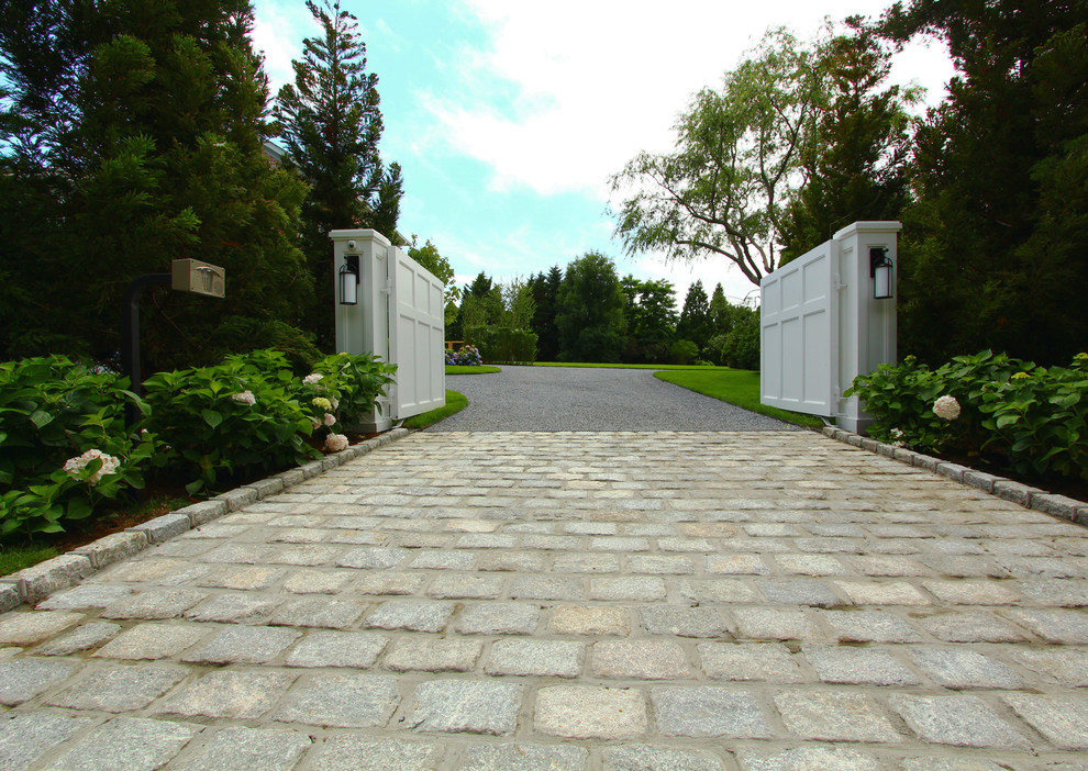 Inspiration for a large transitional front yard full sun driveway in New York with concrete pavers.