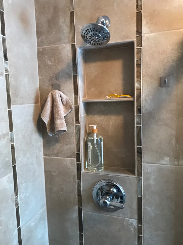 Photo of a small transitional master bathroom in Other with an alcove shower, brown tile, porcelain tile, brown floor, a sliding shower screen and a niche.