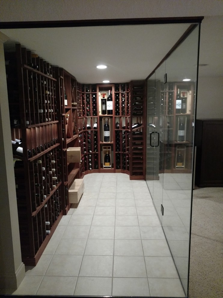 Inspiration for a mid-sized traditional wine cellar in Milwaukee with ceramic floors, storage racks and beige floor.
