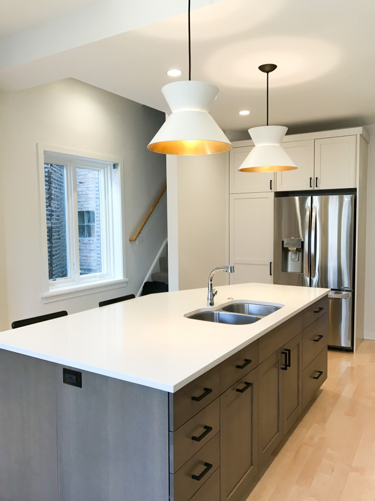 Example of a large transitional l-shaped eat-in kitchen design in Chicago with a double-bowl sink, shaker cabinets, white cabinets, quartz countertops, multicolored backsplash, porcelain backsplash, stainless steel appliances, an island and white countertops
