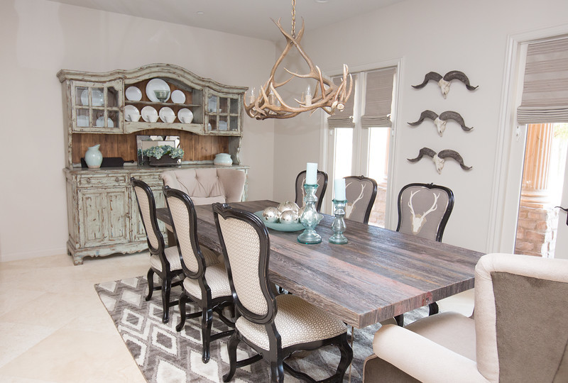 Expansive eclectic separate dining room in Phoenix with white walls and travertine floors.