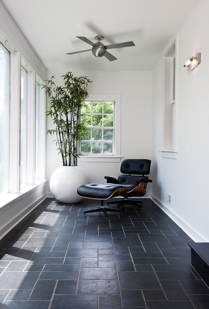 Design ideas for a transitional sunroom in DC Metro with a standard ceiling and black floor.