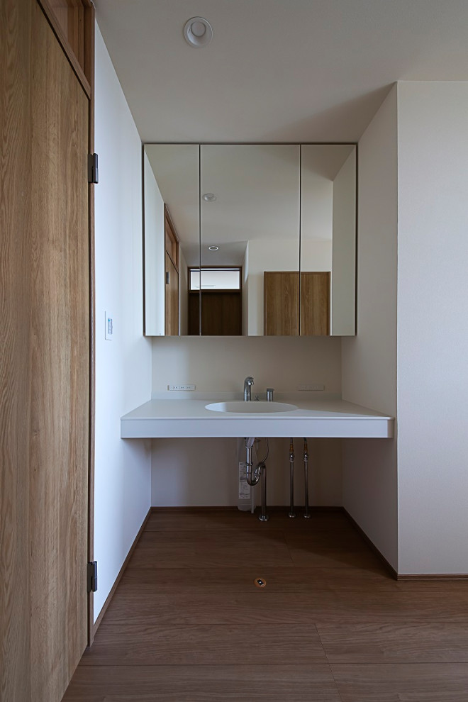 Inspiration for a medium sized scandinavian cloakroom in Other with open cabinets, white cabinets, white tiles, white walls, painted wood flooring, a submerged sink, solid surface worktops, beige floors, white worktops, a built in vanity unit, a wallpapered ceiling and wallpapered walls.