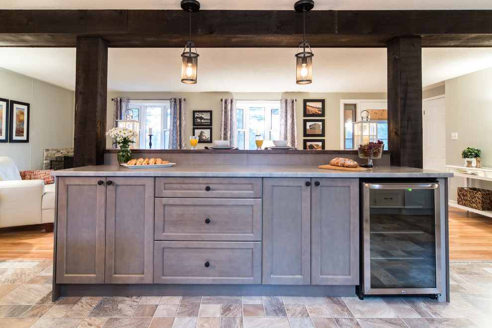 Inspiration for a mid-sized transitional galley open plan kitchen in Toronto with shaker cabinets, brown cabinets, zinc benchtops, stainless steel appliances, light hardwood floors and with island.