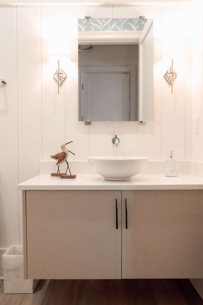 Small beach style bathroom in Other with flat-panel cabinets, beige cabinets, white walls, light hardwood flooring, a vessel sink, quartz worktops, brown floors, white worktops, a single sink, a floating vanity unit and wood walls.