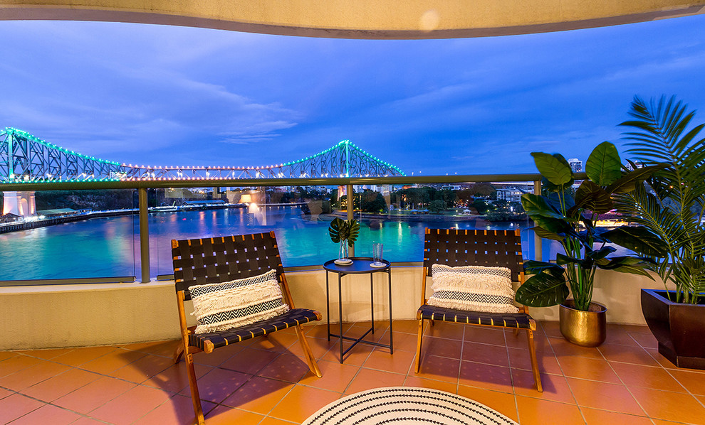 Design ideas for a small transitional balcony in Brisbane with a roof extension and mixed railing.