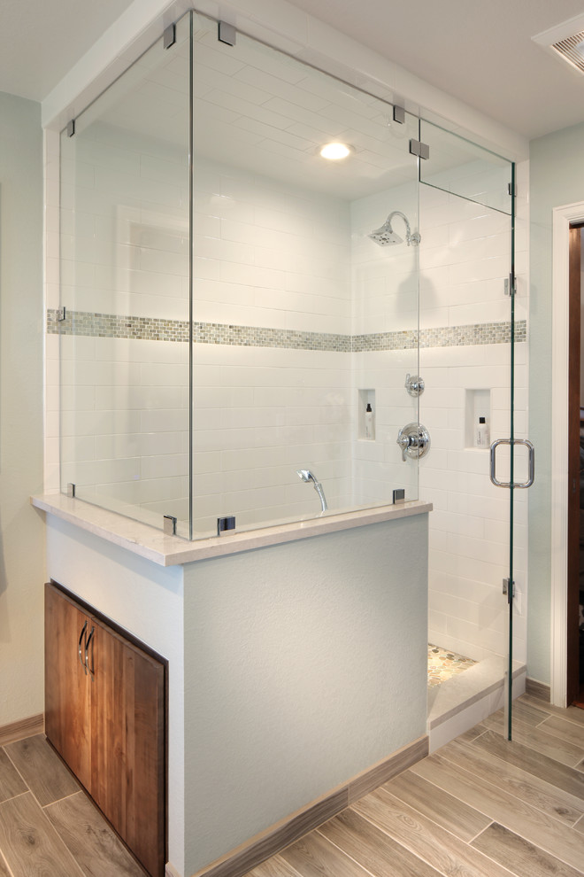 Example of a transitional master white tile and mosaic tile porcelain tile bathroom design in Denver with flat-panel cabinets, medium tone wood cabinets, an undermount sink and quartz countertops