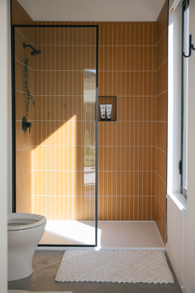 Inspiration for a scandinavian bathroom in Other with yellow tile and glass tile.