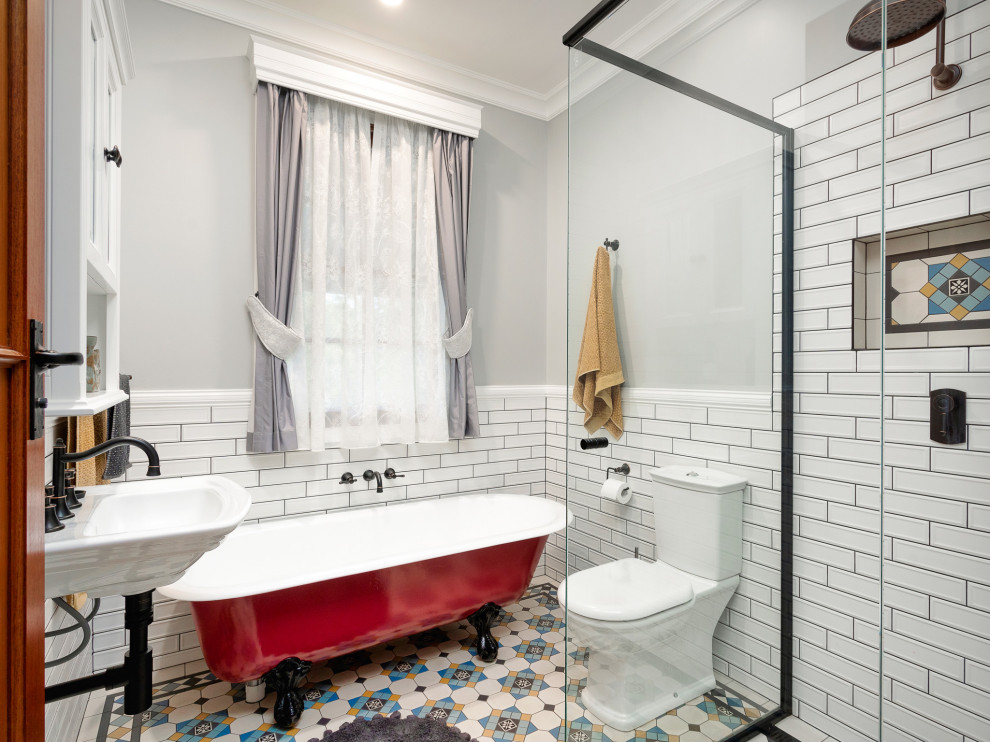 Photo of a small country kids bathroom in Brisbane with a claw-foot tub, a corner shower, a one-piece toilet, white tile, subway tile, grey walls, mosaic tile floors, a hinged shower door, a niche, a single vanity and a floating vanity.