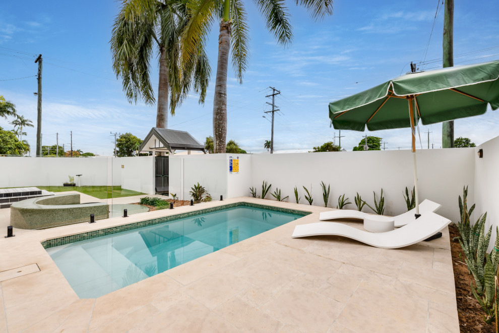 Inspiration pour un piscine avec aménagement paysager vintage rectangle avec une cour et des pavés en pierre naturelle.
