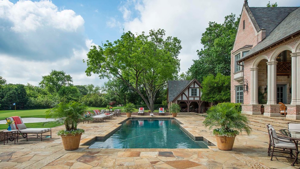 Inspiration for a traditional rectangular pool in Dallas with natural stone pavers.