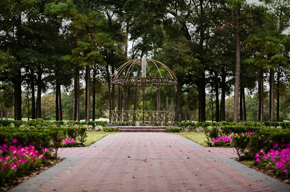 Design ideas for a large traditional backyard partial sun formal garden in Houston with a garden path and brick pavers.