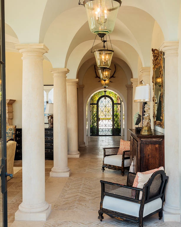 Inspiration for a mediterranean hallway in Los Angeles with beige walls, limestone floors and beige floor.