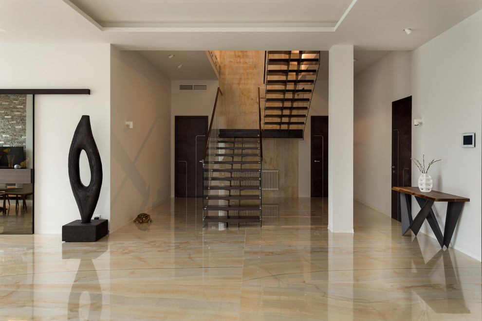 Large scandinavian travertine u-shaped staircase in Moscow with travertine risers, wood railing and wallpaper.
