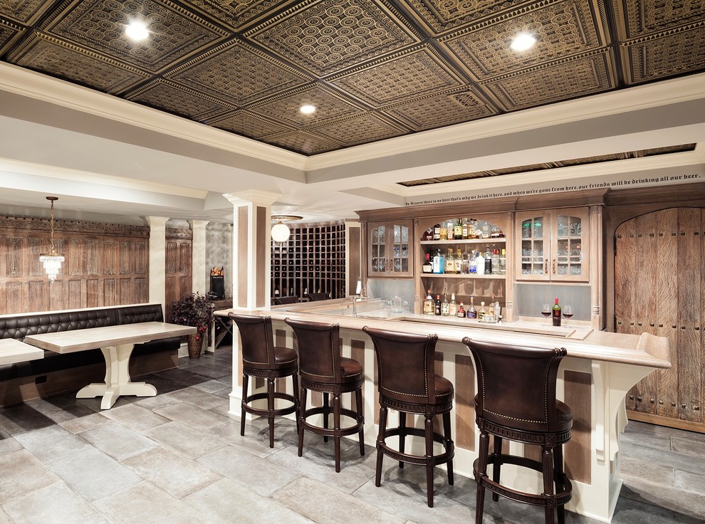 Traditional u-shaped wet bar in Chicago with ceramic floors, glass-front cabinets, medium wood cabinets and grey floor.