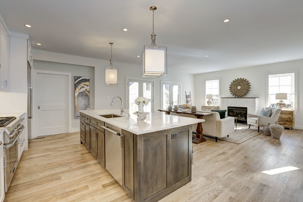 Inspiration for a large modern single-wall light wood floor and beige floor open concept kitchen remodel in DC Metro with an undermount sink, shaker cabinets, white cabinets, quartz countertops, white backsplash, ceramic backsplash, stainless steel appliances, an island and white countertops