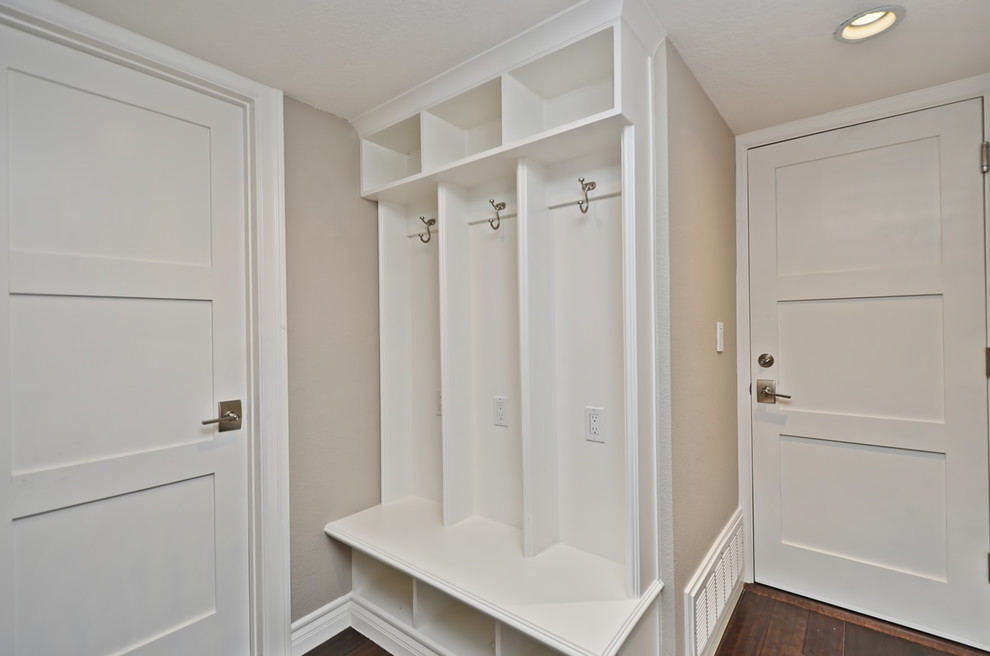 This is an example of a small arts and crafts mudroom in San Francisco with beige walls and dark hardwood floors.