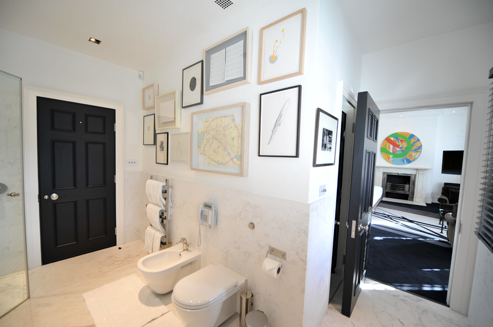 This is an example of a bathroom in Kent with a freestanding tub, a corner shower, stone slab, white walls, marble floors and marble benchtops.