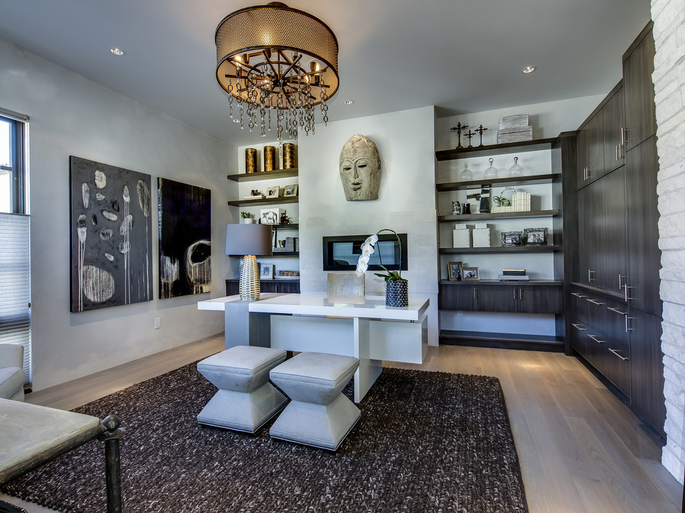 Contemporary home office in Denver with grey walls, medium hardwood floors, a ribbon fireplace and a freestanding desk.