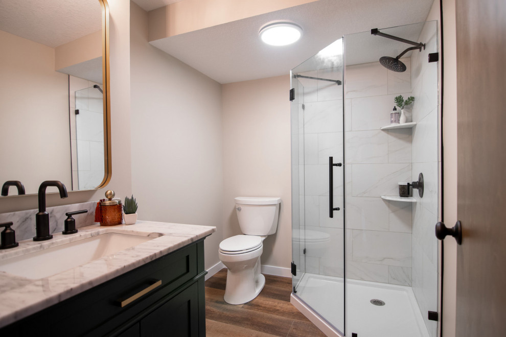 Mid-sized elegant 3/4 beige tile and porcelain tile vinyl floor, brown floor and single-sink corner shower photo in Other with shaker cabinets, green cabinets, a one-piece toilet, beige walls, an integrated sink, quartz countertops, a hinged shower door, white countertops and a freestanding vanity