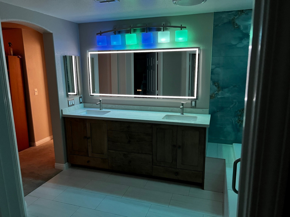 Inspiration for a mid-sized traditional master bathroom in Las Vegas with shaker cabinets, brown cabinets, engineered quartz benchtops, white benchtops, a double vanity and a built-in vanity.