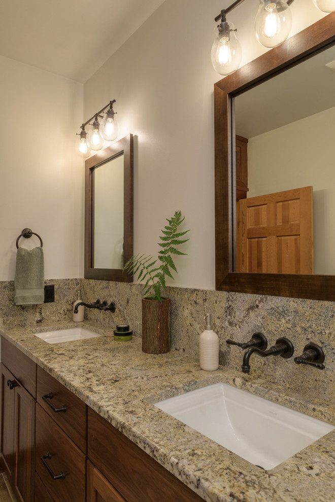 Mid-sized contemporary master wet room bathroom with shaker cabinets, medium wood cabinets, a freestanding tub, a one-piece toilet, beige walls, an undermount sink, granite benchtops, a hinged shower door, dark hardwood floors, grey floor, pebble tile and beige tile.