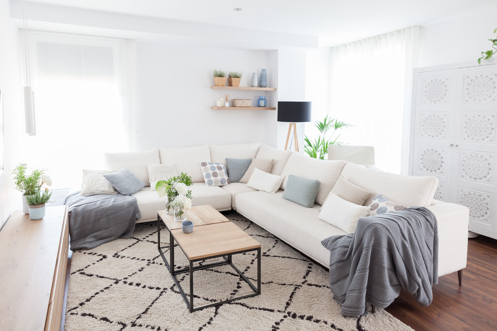 Scandinavian formal enclosed living room in Madrid with white walls, dark hardwood floors and brown floor.