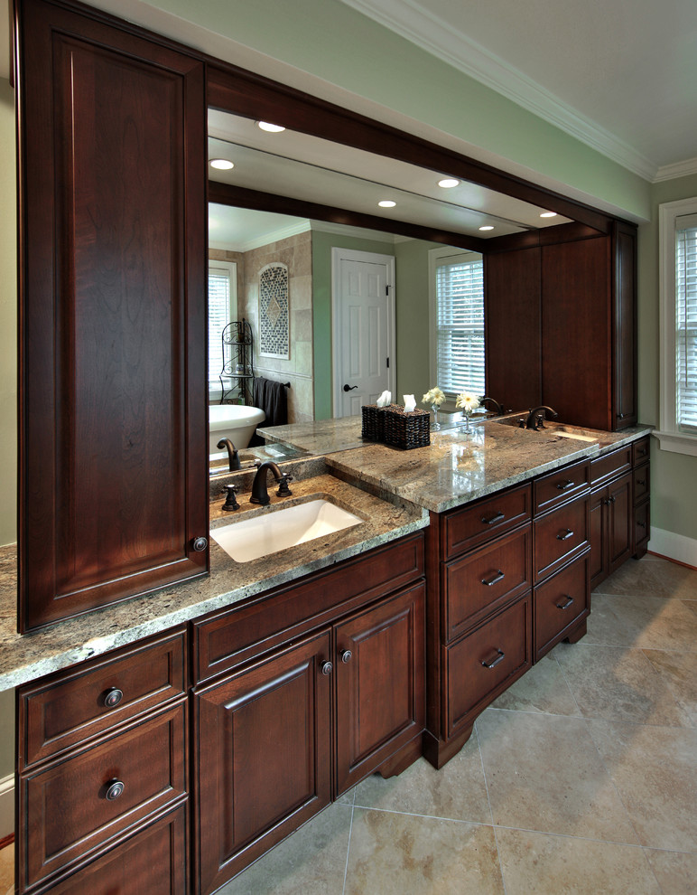 Design ideas for a large arts and crafts master bathroom in DC Metro with an undermount sink, recessed-panel cabinets, dark wood cabinets, granite benchtops, a freestanding tub, beige tile, stone tile, green walls and marble floors.