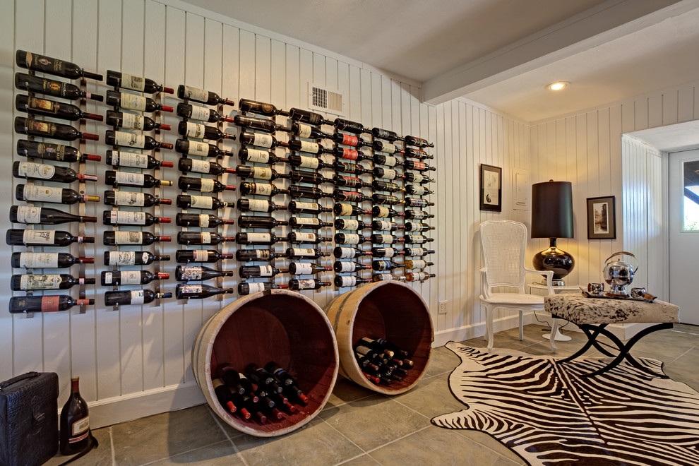 This is an example of a large country wine cellar in Atlanta with slate floors, storage racks and grey floor.