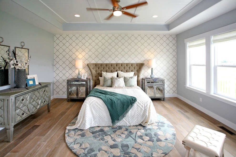 This is an example of a large transitional master bedroom in Salt Lake City with grey walls, medium hardwood floors, no fireplace and brown floor.