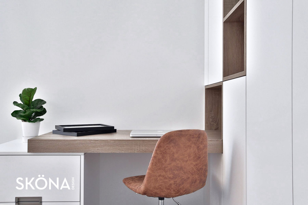 This is an example of a scandinavian home office in Toronto with a built-in desk.