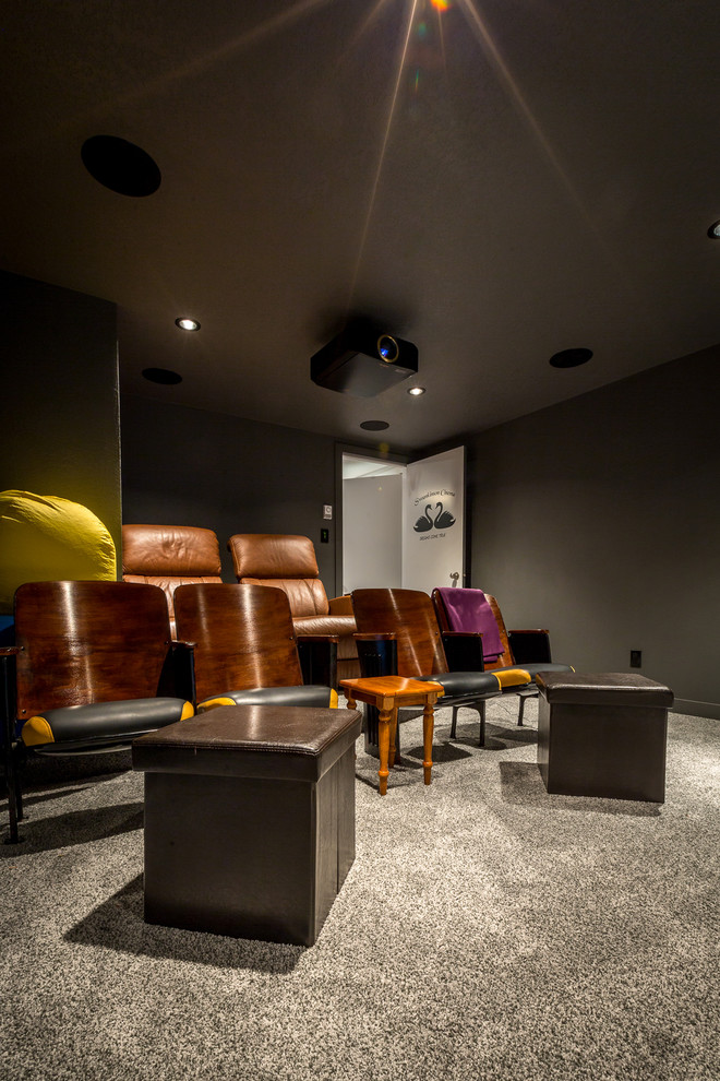 Inspiration for a mid-sized traditional enclosed home theatre in Calgary with grey walls, carpet, a projector screen and grey floor.