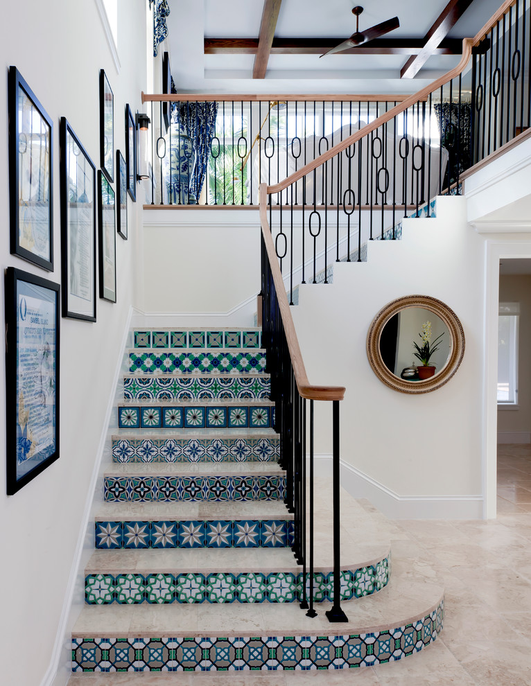 This is an example of a mid-sized mediterranean tile l-shaped staircase in Tampa with tile risers.