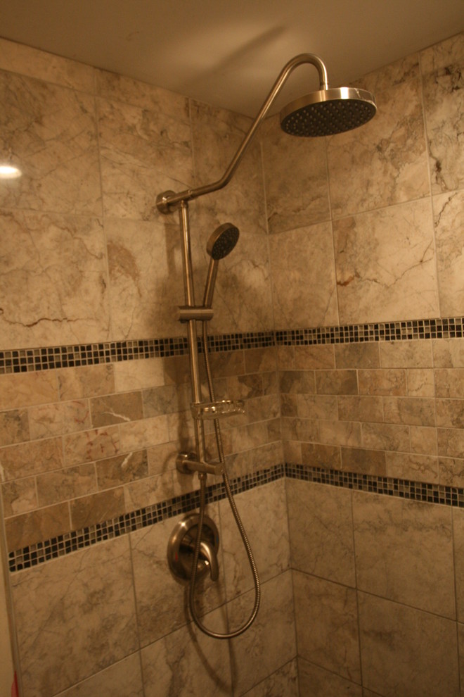 This is an example of a mid-sized modern master bathroom in DC Metro with a corner shower, beige tile and ceramic tile.