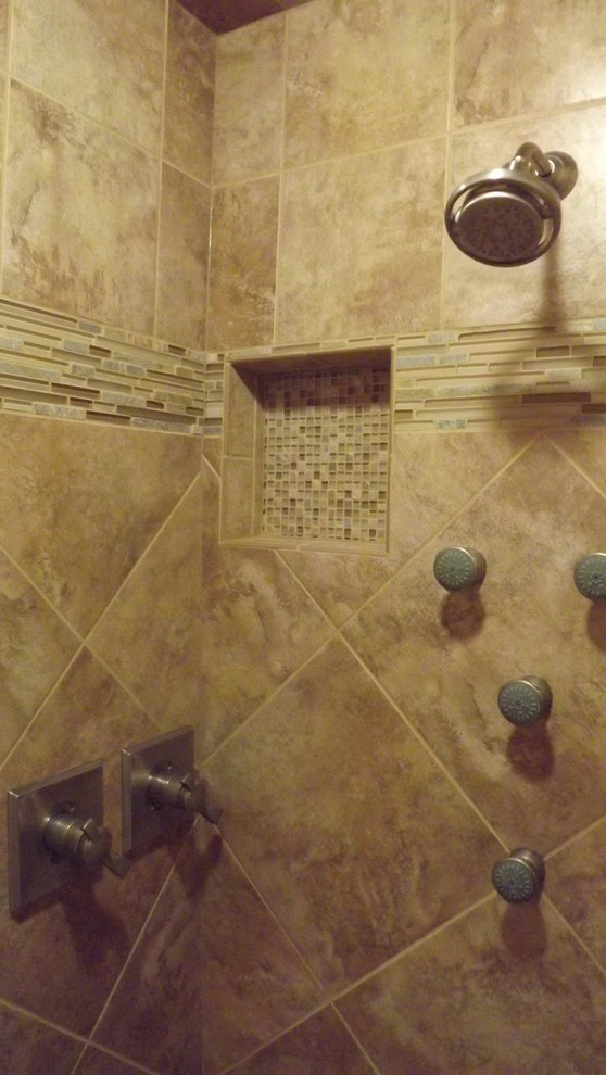Inspiration for a transitional beige tile and porcelain tile porcelain tile doorless shower remodel with an undermount sink, raised-panel cabinets, medium tone wood cabinets, granite countertops and beige walls