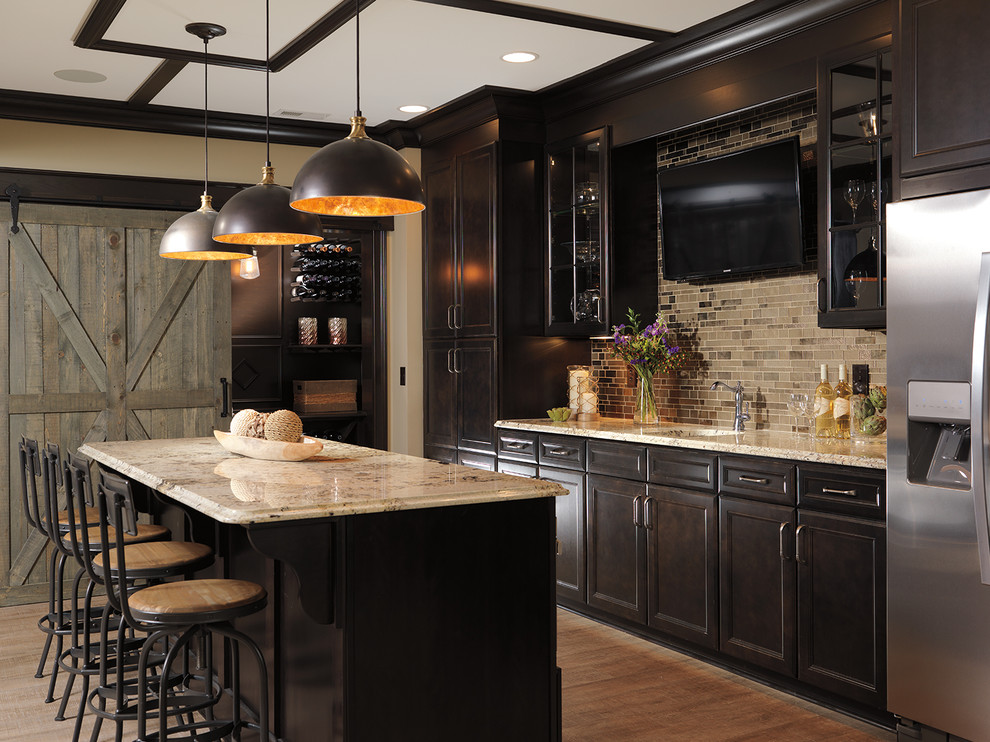 Large traditional kitchen in Indianapolis with dark wood cabinets, beige splashback, stainless steel appliances, with island and recessed-panel cabinets.