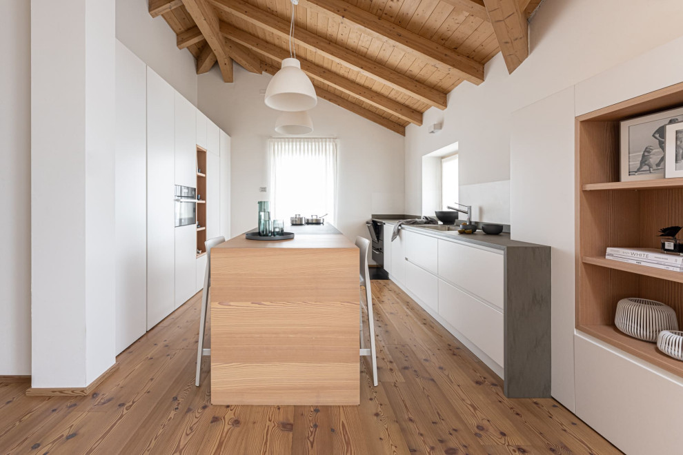 Design ideas for a modern galley kitchen/diner in Other with granite worktops, dark hardwood flooring, an island, grey worktops and exposed beams.
