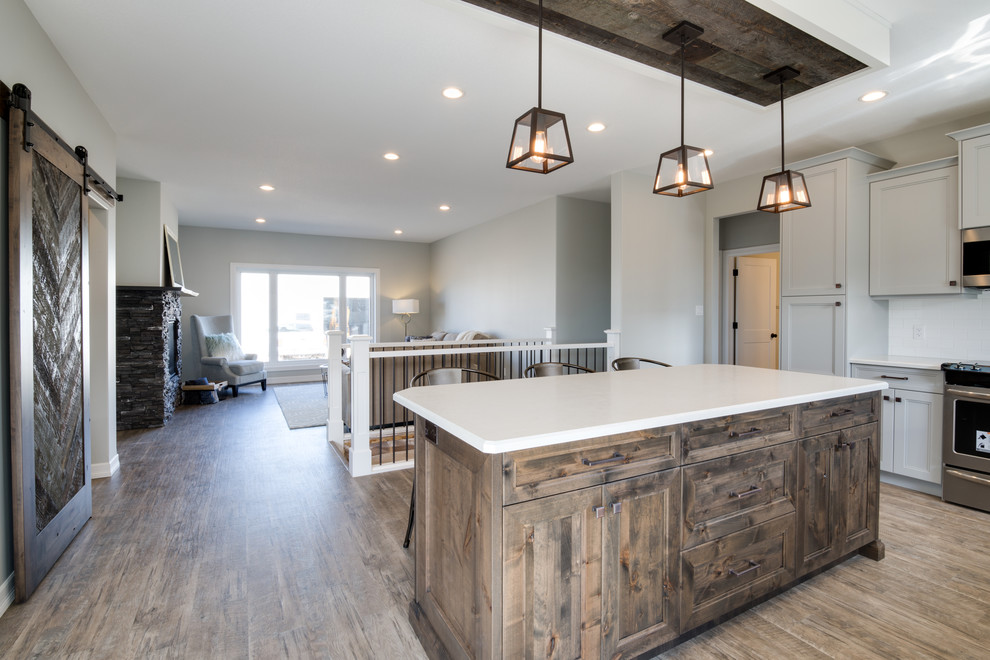 Inspiration for a large transitional l-shaped open concept kitchen remodel in Calgary with shaker cabinets, gray cabinets, laminate countertops, stainless steel appliances and an island