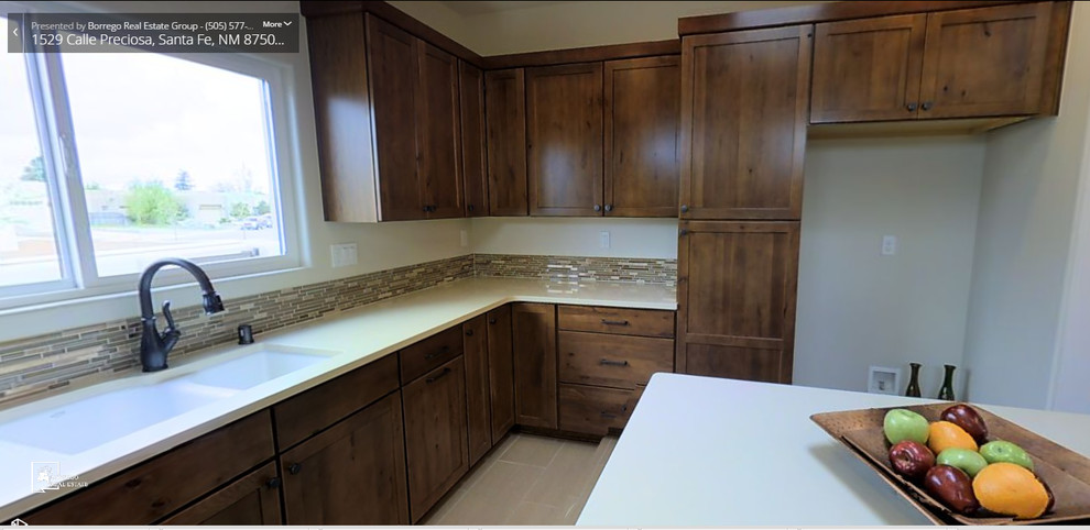 Photo of a mid-sized modern u-shaped eat-in kitchen in Albuquerque with an undermount sink, shaker cabinets, distressed cabinets, quartz benchtops, multi-coloured splashback, mosaic tile splashback, travertine floors and with island.