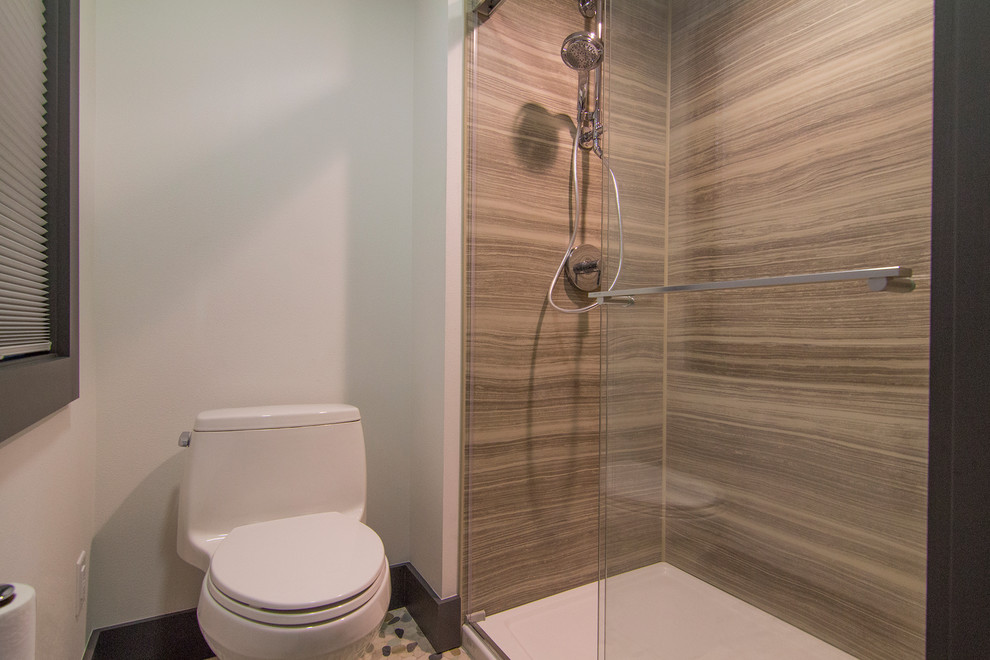 Small contemporary 3/4 bathroom in Milwaukee with an alcove shower, a one-piece toilet, white walls and pebble tile floors.